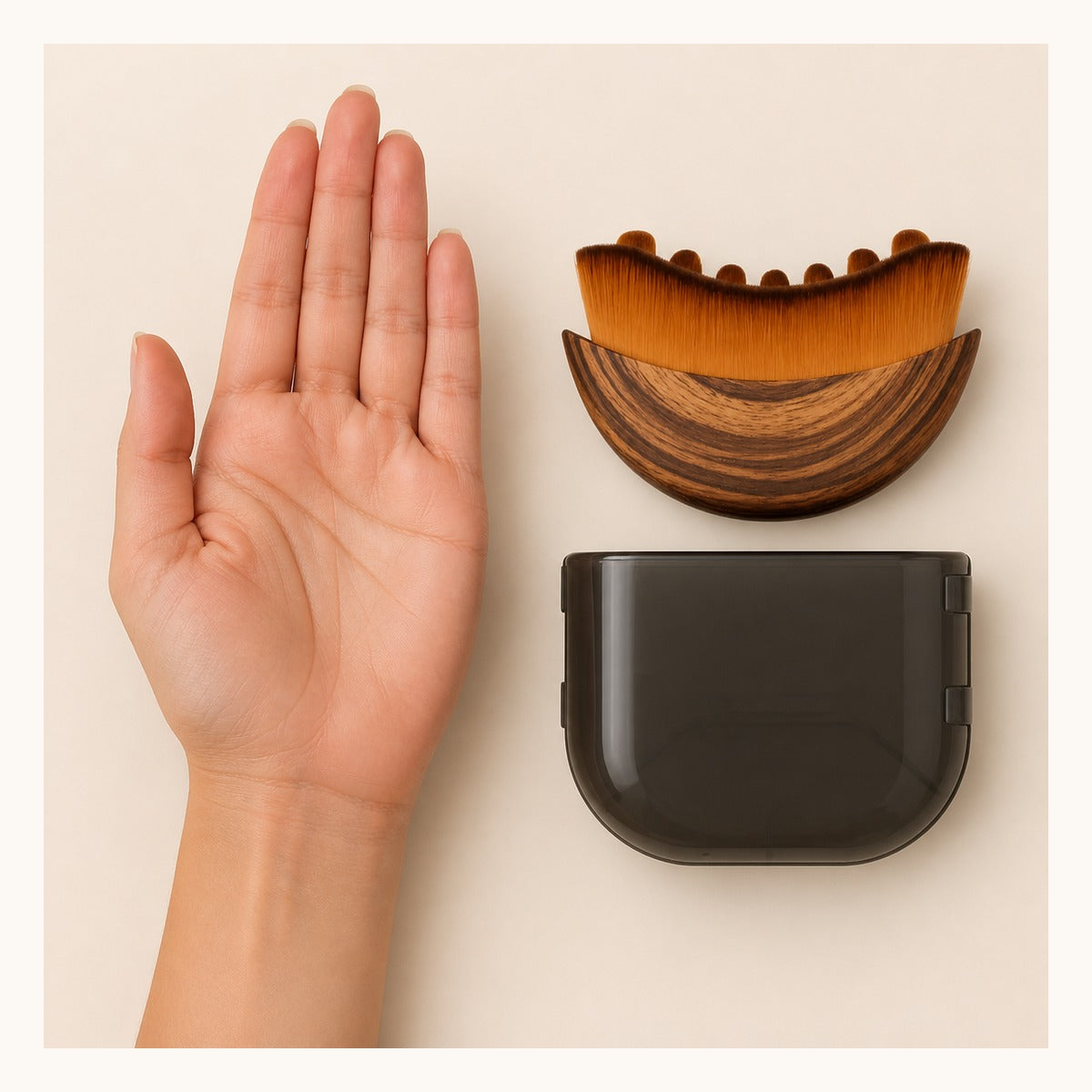 Glowlift brush and case beside an open palm for size context