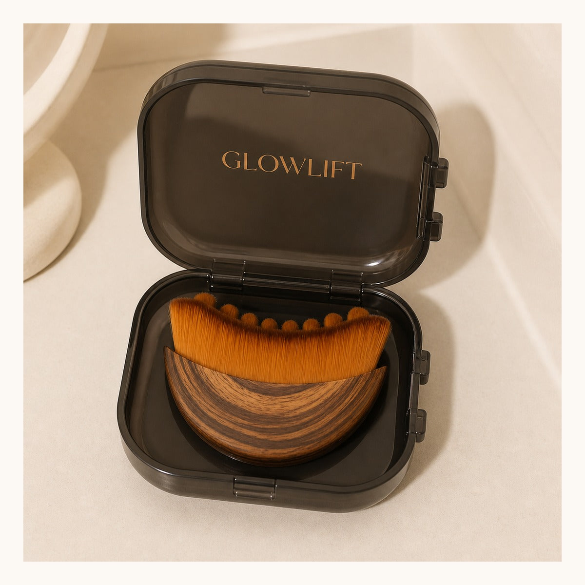 Brown Glowlift brush nested in its open dark case