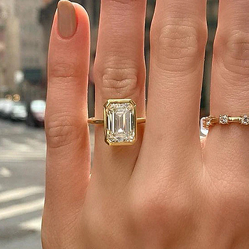 Elegant Emerald Cut Sterling Silver Bezel Engagement Ring In Golden Tone Shineofdiamond