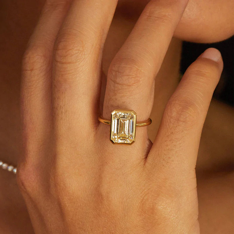 Elegant Emerald Cut Sterling Silver Bezel Engagement Ring In Golden Tone Shineofdiamond