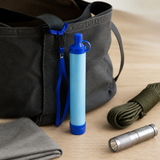 AI-generated illustrative placement example of an Aquor filter straw beside emergency-kit accessories