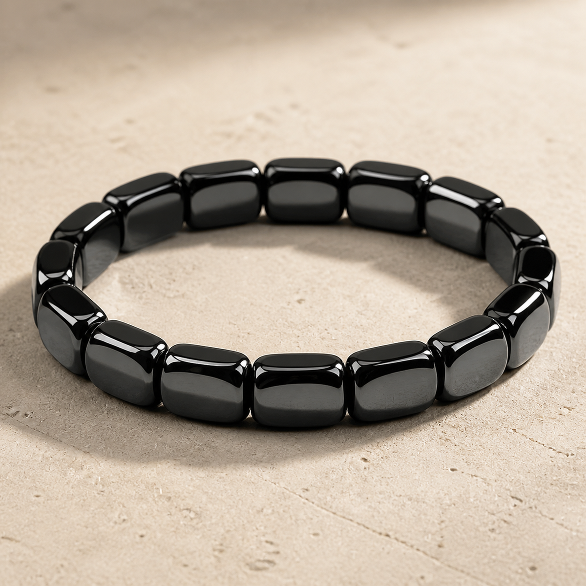 Dravyn black tile-bead bracelet on pale stone