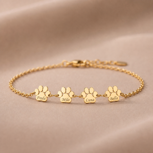 Delicate Everpaw gold paw name bracelet with four petite engraved charms