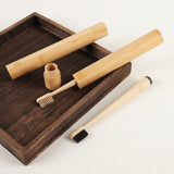 Gumcrest bamboo toothbrushes and travel tubes on a tray