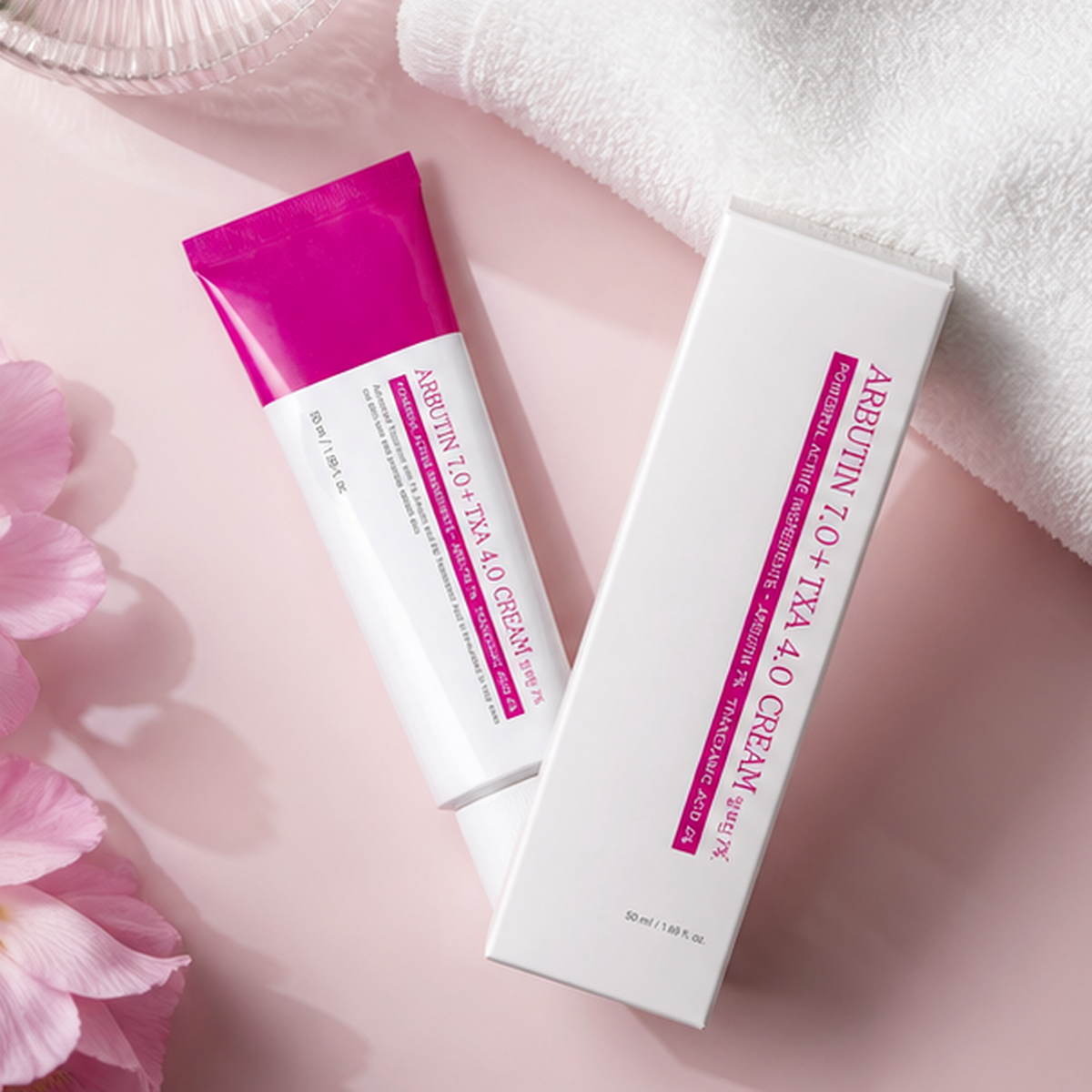 Aurela cream and carton on a pink towel flatlay