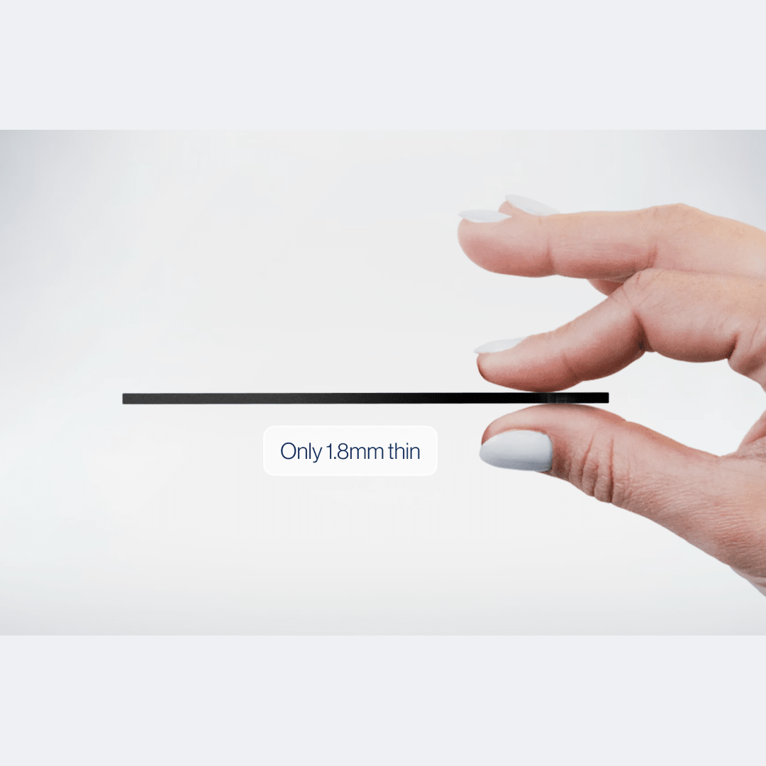 A hand pinching the Locca card to show it is only 1.8 mm thin