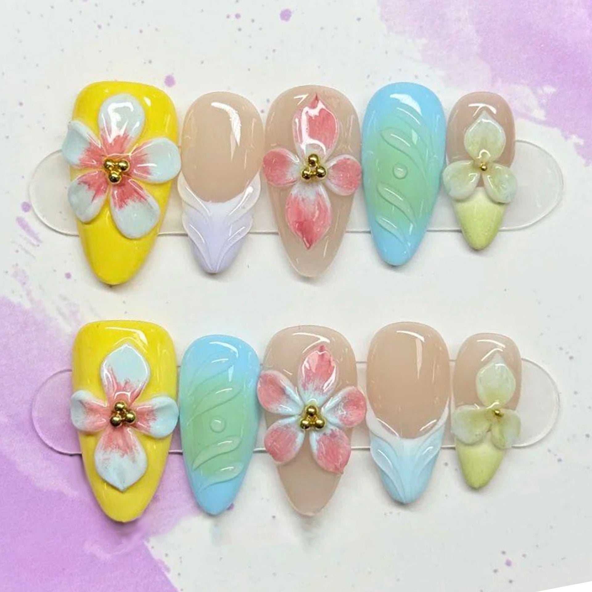 Blossira floral almond press-on nails, close view of ten painted tips