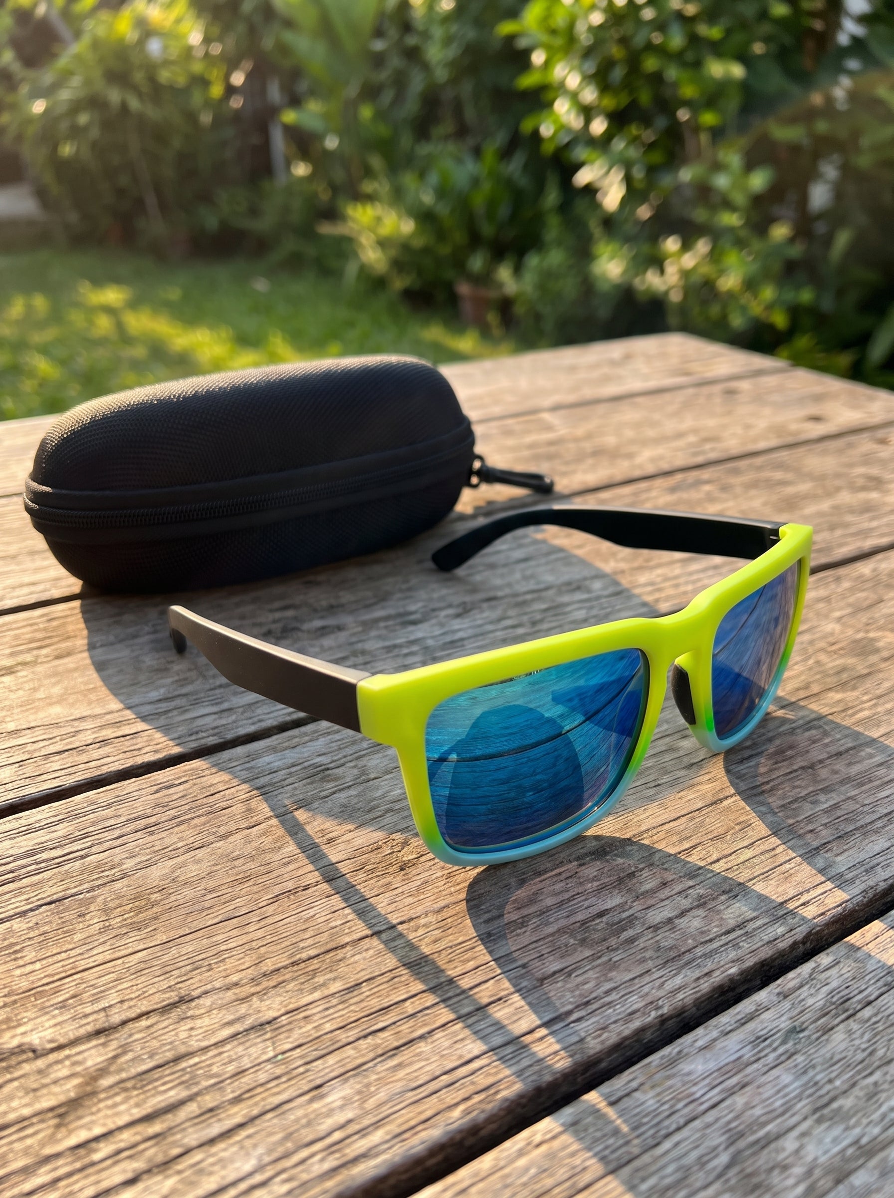Kestryn sunglasses and protective case on a sunlit table