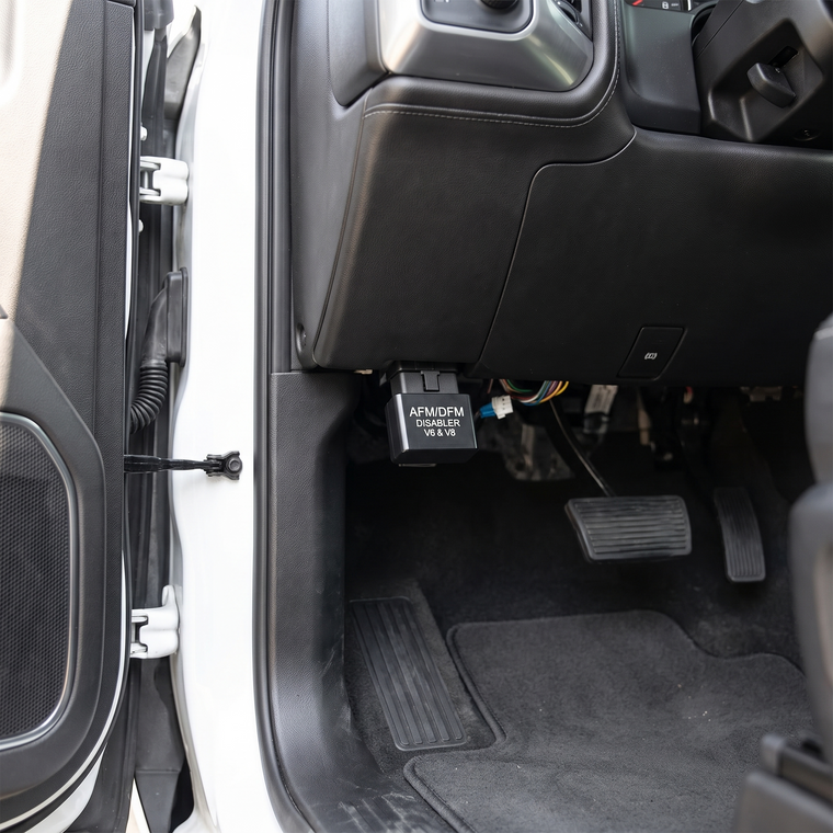 REVLOCK plugged into the OBD-II port under a truck dashboard